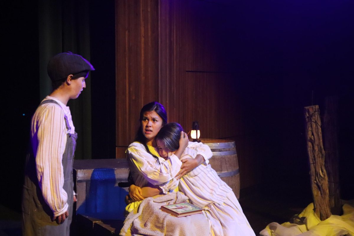 Audrey Winn, 12, and Aly Alcala, 11, perform a scene together in Waxahachie High School's Fall 2024 production of Storm in the Barn. 